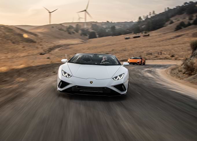 White Lamborghini Huracan driving on road