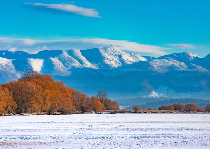 Snowy Mountains and Frozen Lake