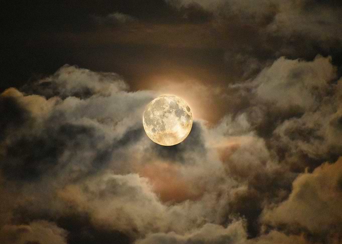 Full Moon Amidst Cloudy Sky