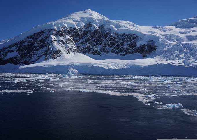 Antarctic Landscape with Icebergs and Mountain