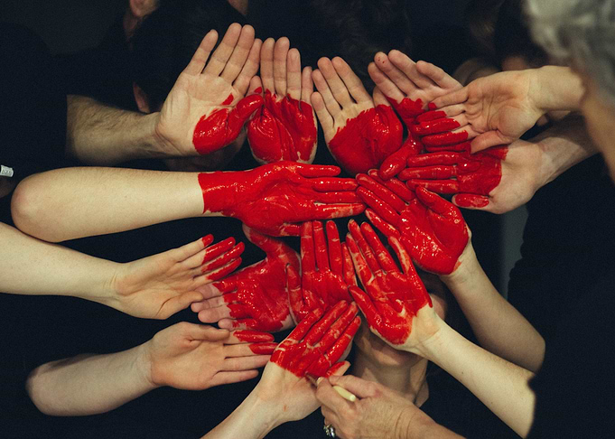 Red Painted Hands Together