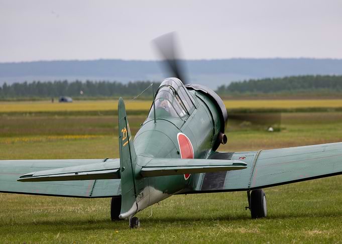 Japanese WWII Aircraft on Grassy Field