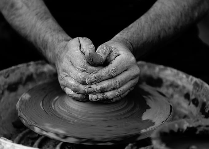 Potter's Hands Shaping Clay on Wheel