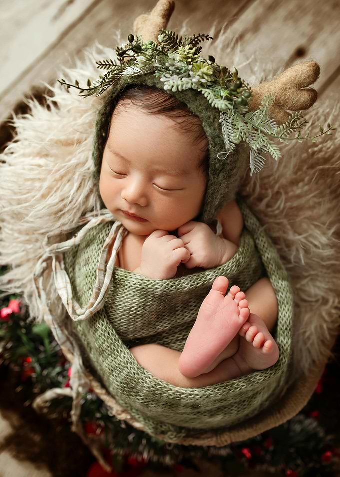 Newborn baby in a deer costume