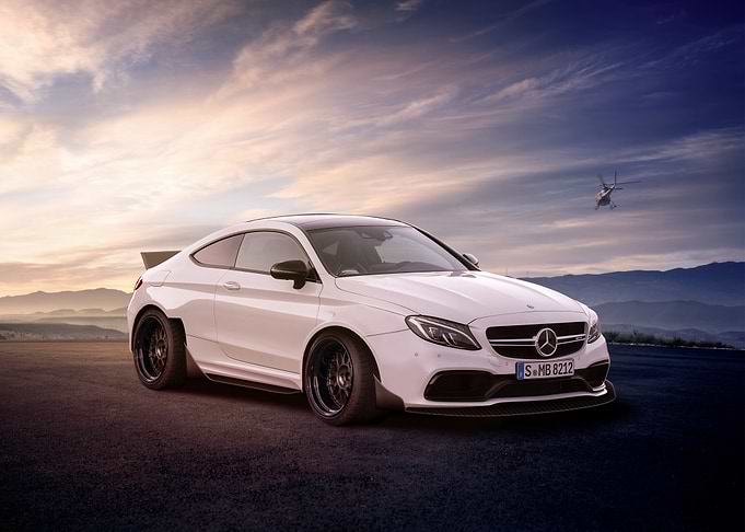 White Mercedes-Benz Coupe with Helicopter Backdrop