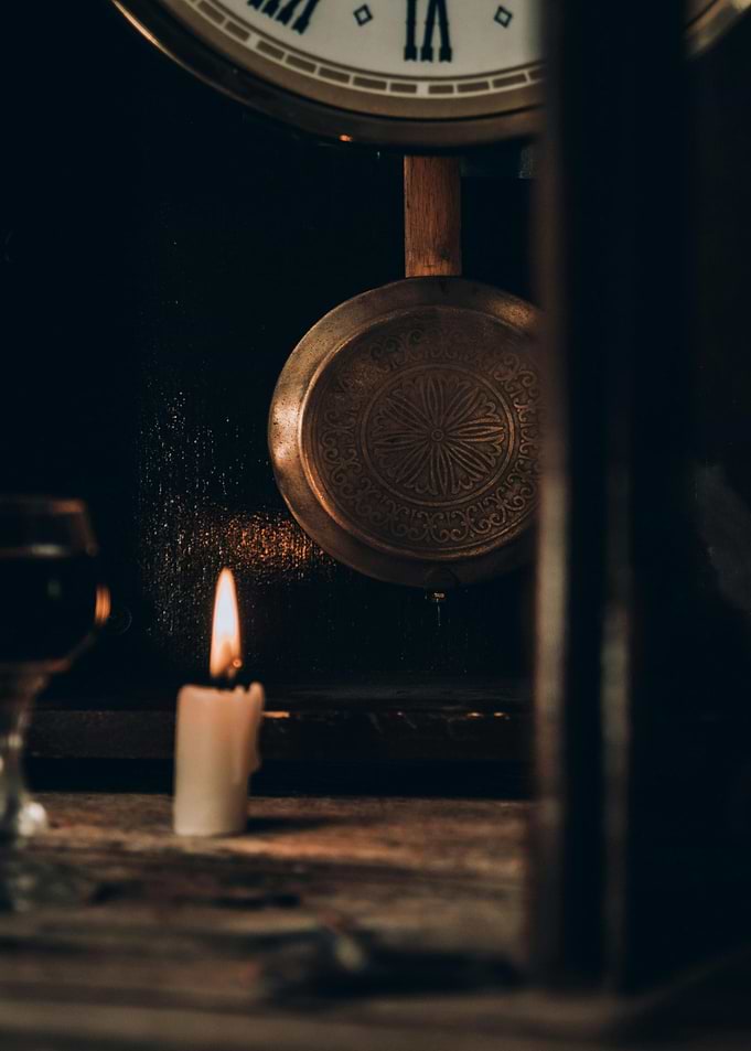 Vintage Clock with Candlelight Still Life