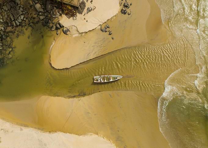 Aerial view of boat on sandy beach
