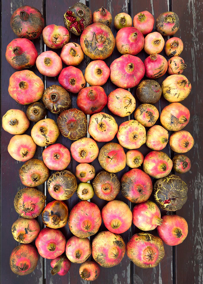 Pomegranates on Dark Wood Surface