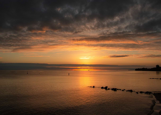 Golden Sunrise Over Calm Ocean Waters
