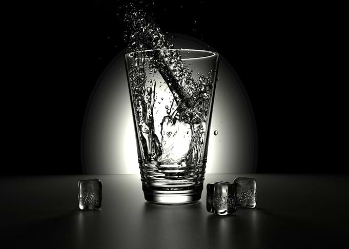 Water splash in glass with ice