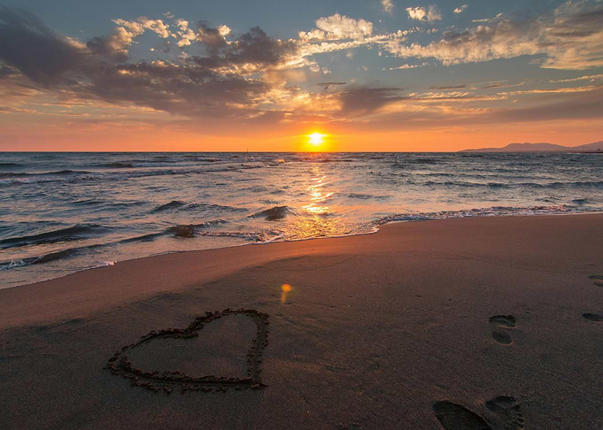 Sunset beach with heart in sand