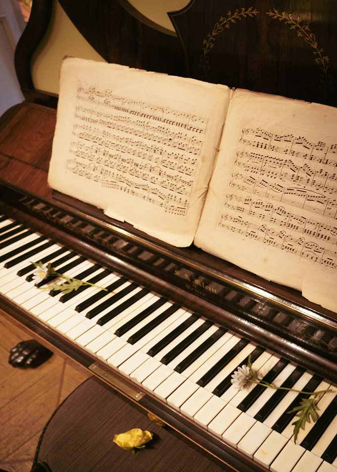 Piano with Sheet Music and Flowers
