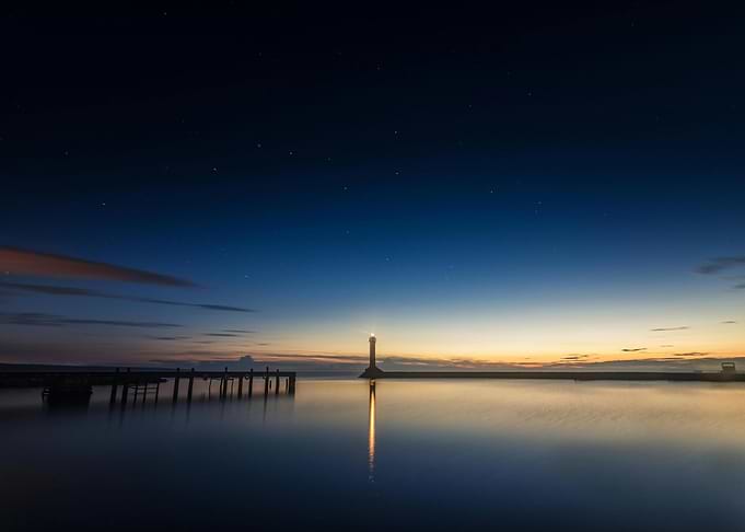 Lighthouse at Night with Starry Sky