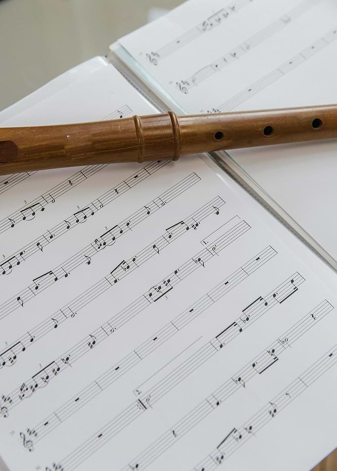 Wooden flute on sheet music