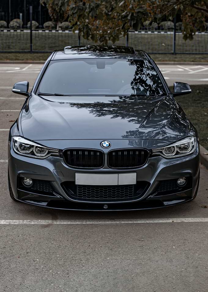 Gray BMW parked in a lot