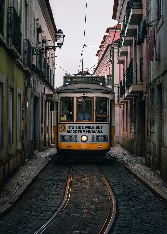 Lisbon Tram on Cobblestone Street