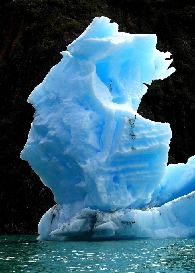 Majestic Blue Iceberg in Dark Waters