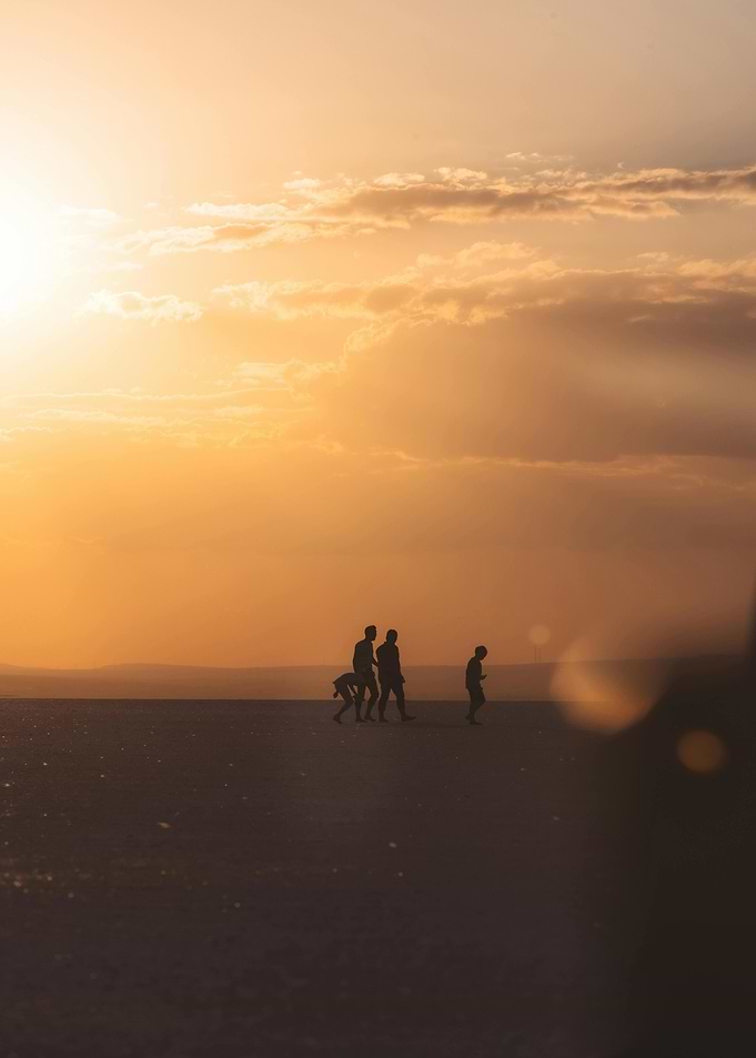 Silhouetted figures at sunset