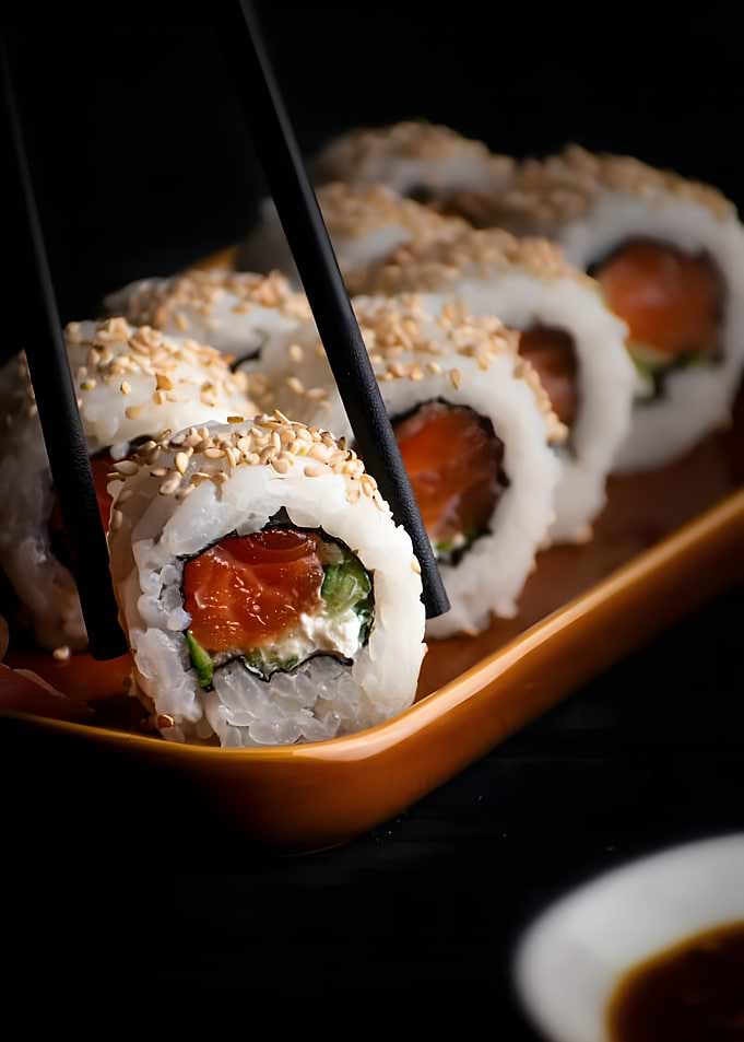 Sushi roll with chopsticks close-up shot