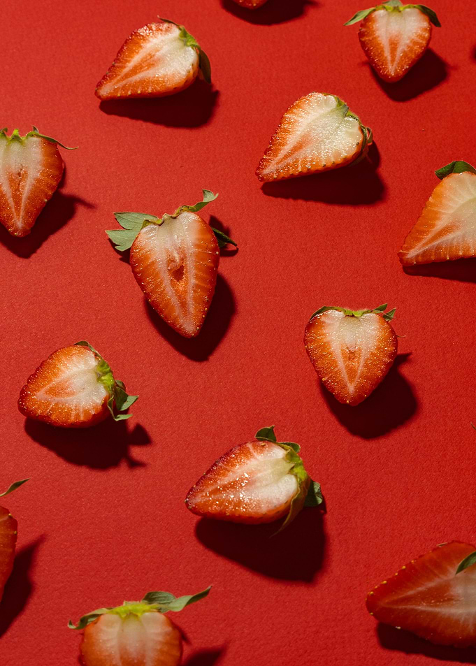 Strawberry Halves on Red Background