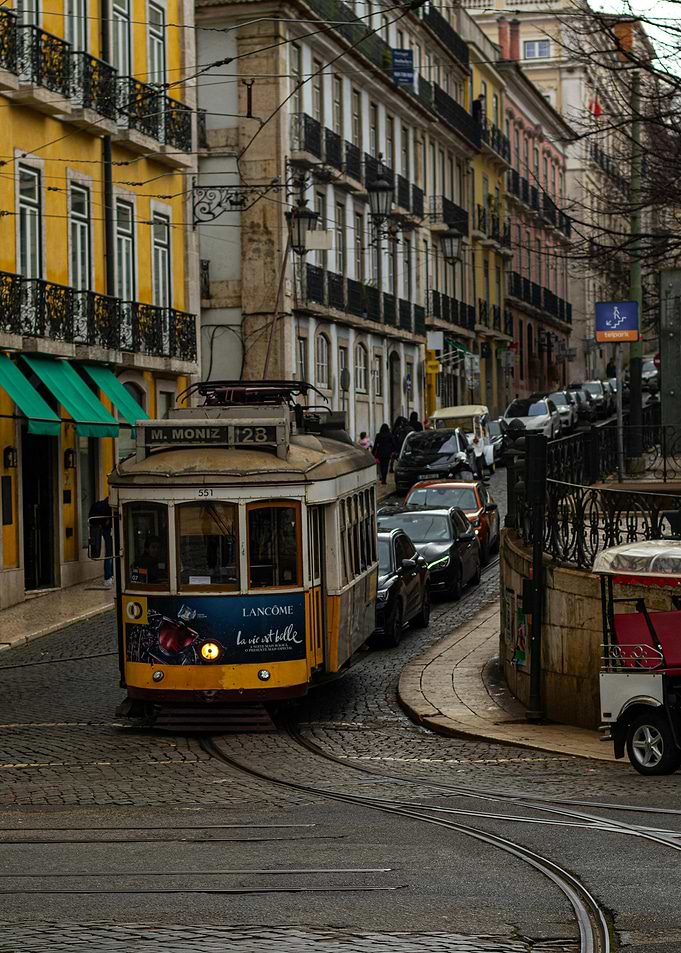Lisbon Tram on Cobblestone Street