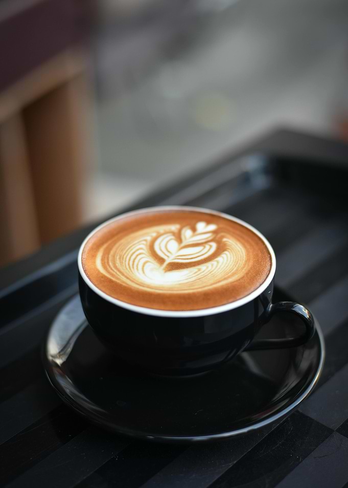 Latte art in black cup