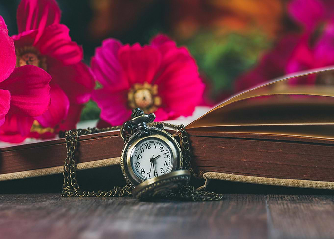 Vintage Pocket Watch on Open Book