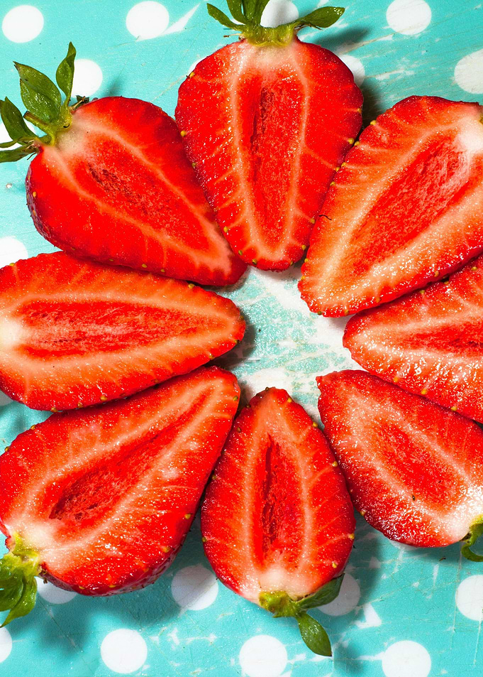 Halved Strawberries on Polka Dot Background
