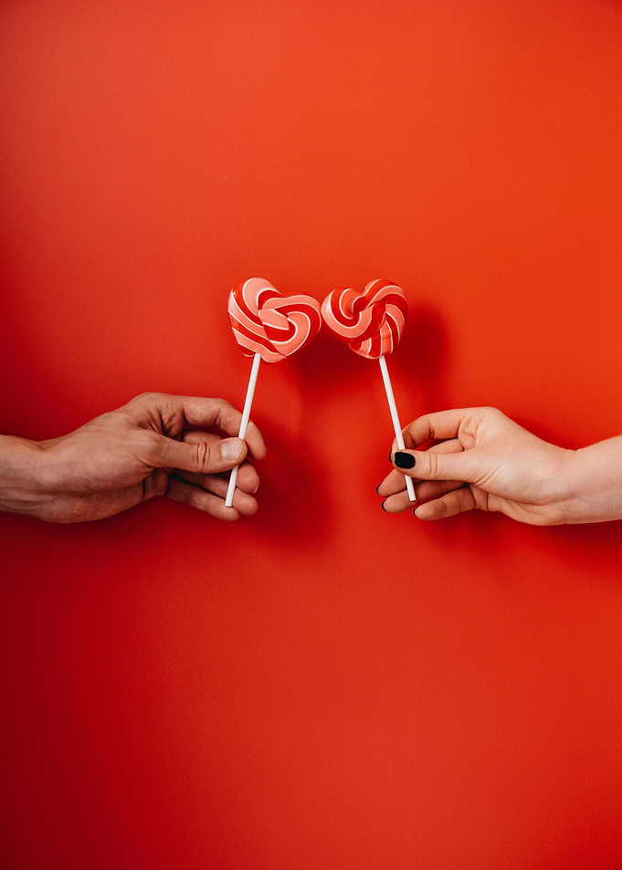 Heart Lollipops on Red Background