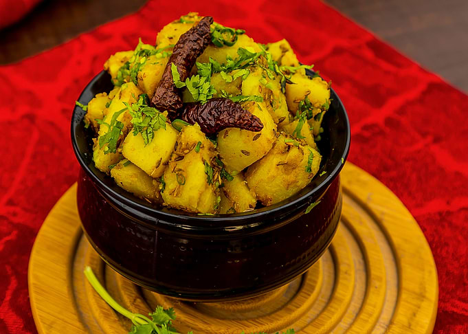 Spicy Potato Dish in Black Bowl