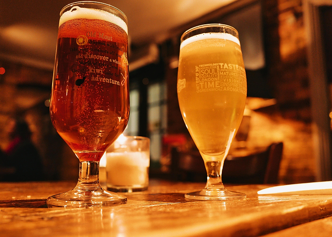 Two Beer Glasses on Wooden Table