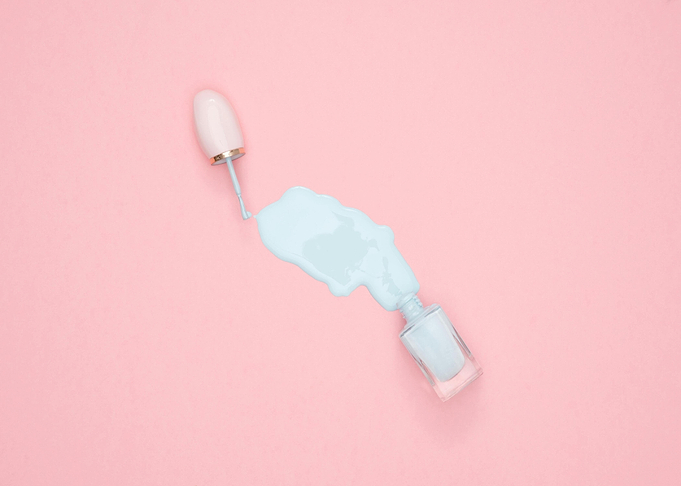 Spilled light blue nail polish on pink