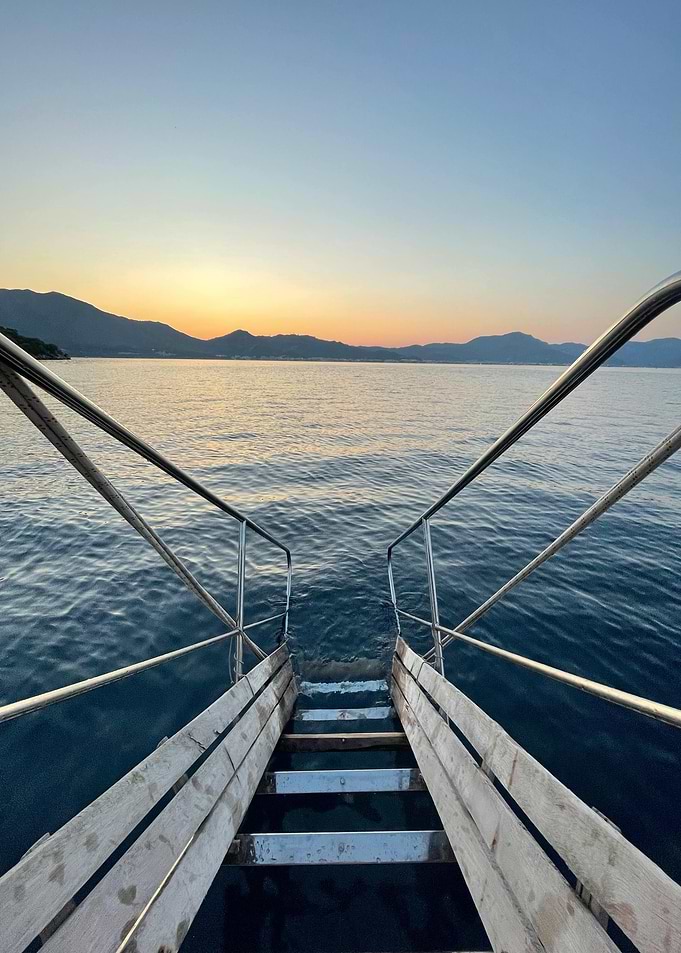 Stairs into the sea at sunset