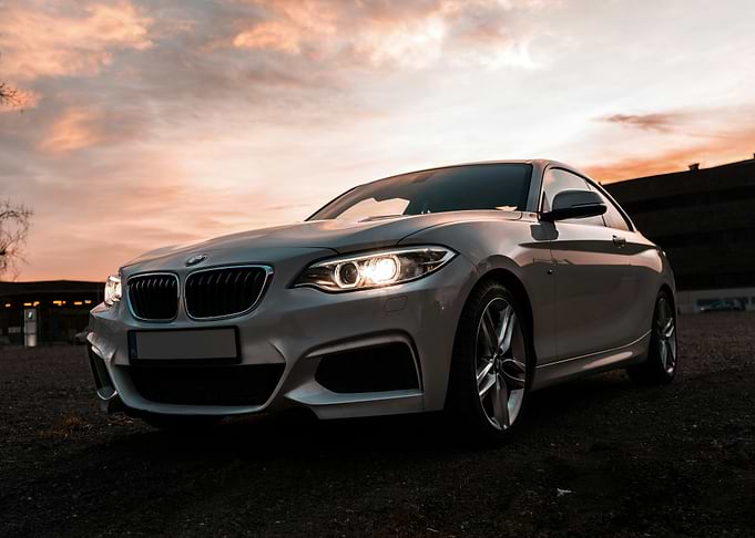 Silver BMW Coupe at Sunset