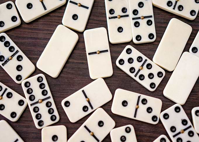 Scattered Dominoes on Wooden Surface