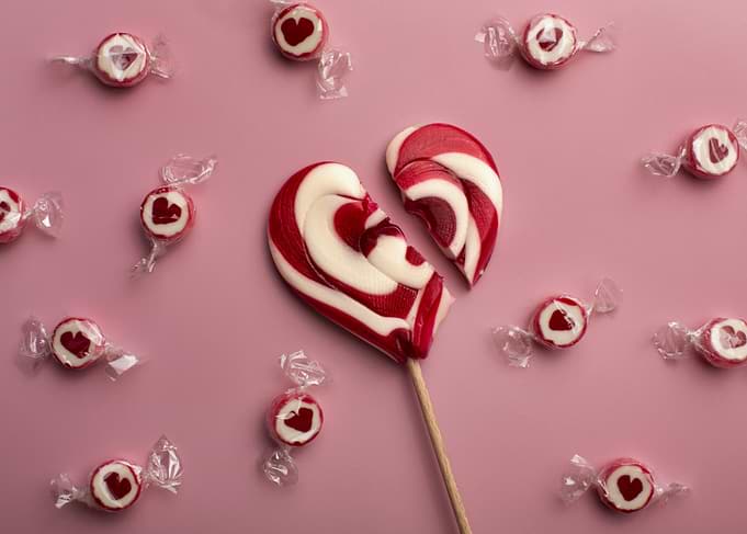 Broken Heart Lollipop on Pink Background