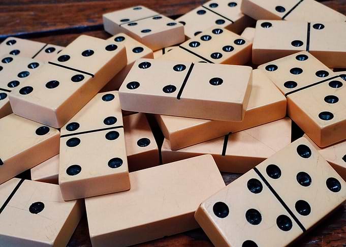 Scattered Domino Tiles on Wooden Surface