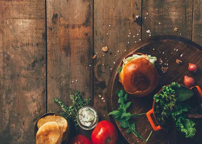 Burger and Ingredients on Wooden Table