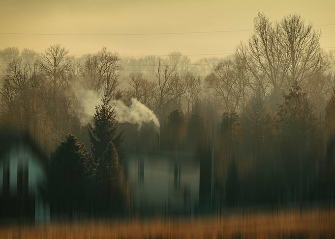 Winter landscape with house and smoke