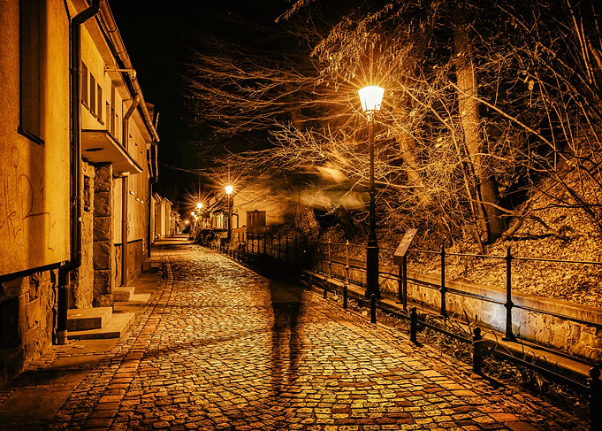 Night street with cobblestone and lamplight, Poland
