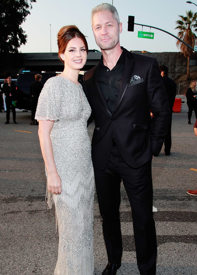 Lana Del Rey and man in suits