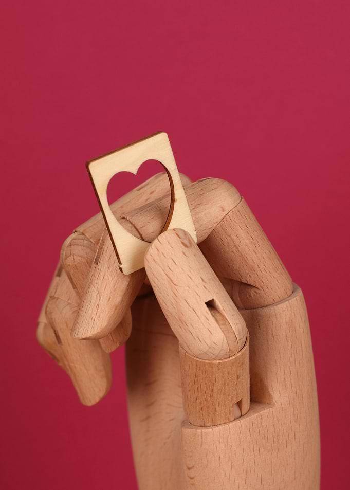 Wooden Hand Holding Heart-Shaped Card