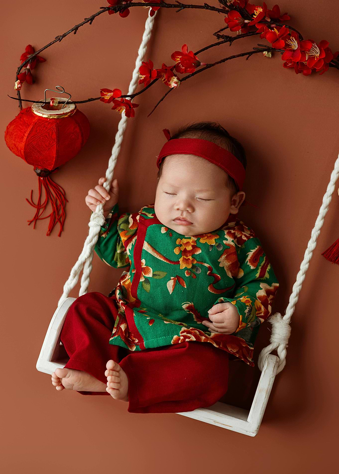 Baby in Traditional Outfit on Swing