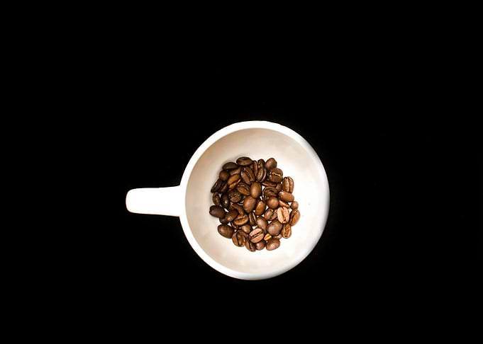 Coffee beans in a white cup