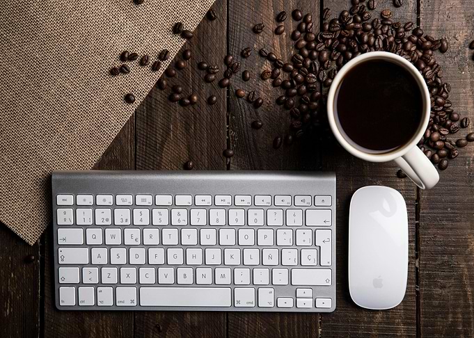 Coffee, Keyboard, and Mouse on Wood