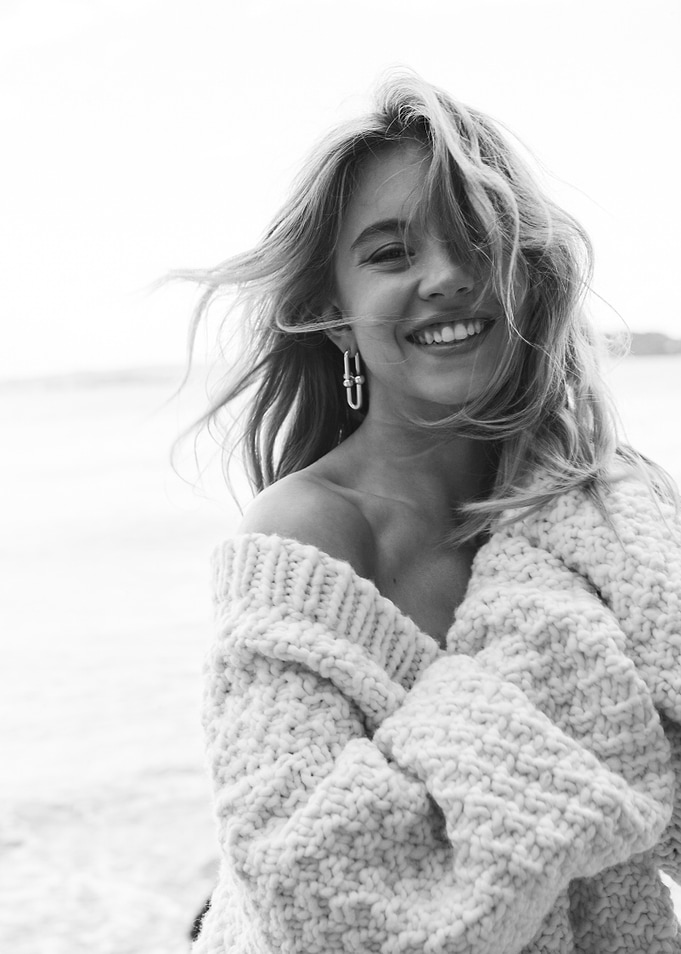 Smiling Woman in Chunky Knit Sweater
