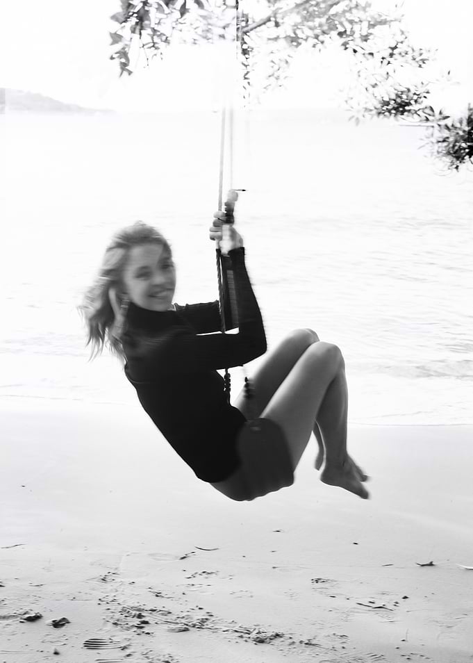 Girl on a swing at the beach
