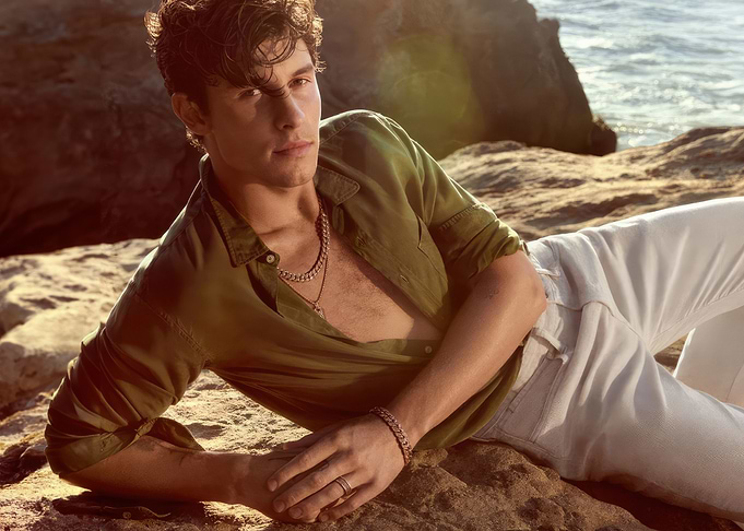 Shawn Mendes Lying on Rocks