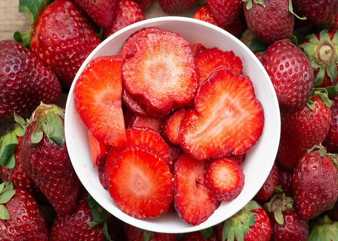 Fresh Strawberries and Slices in Bowl