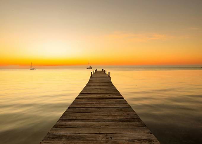 Dock at Sunset with Sailboats